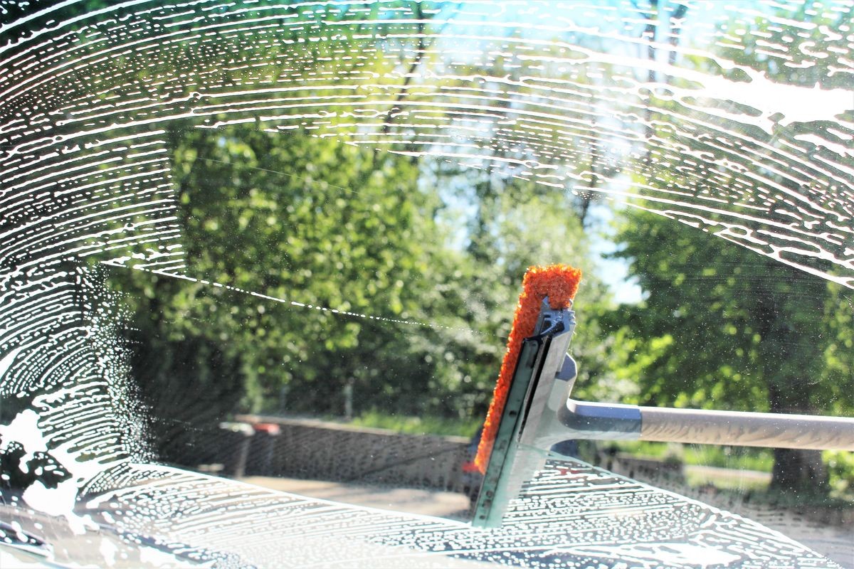 An image of cleaning a car window